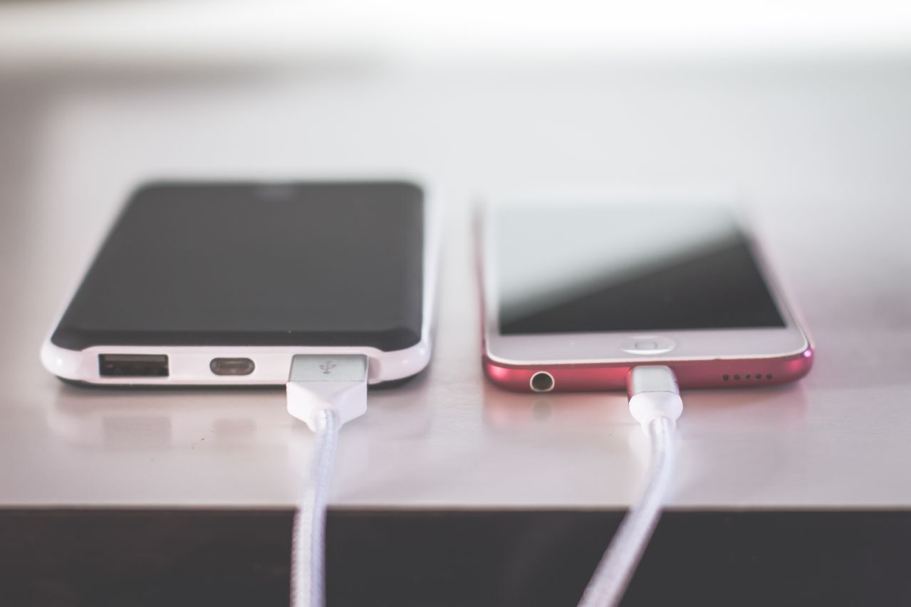 Two cell phones charging side by side